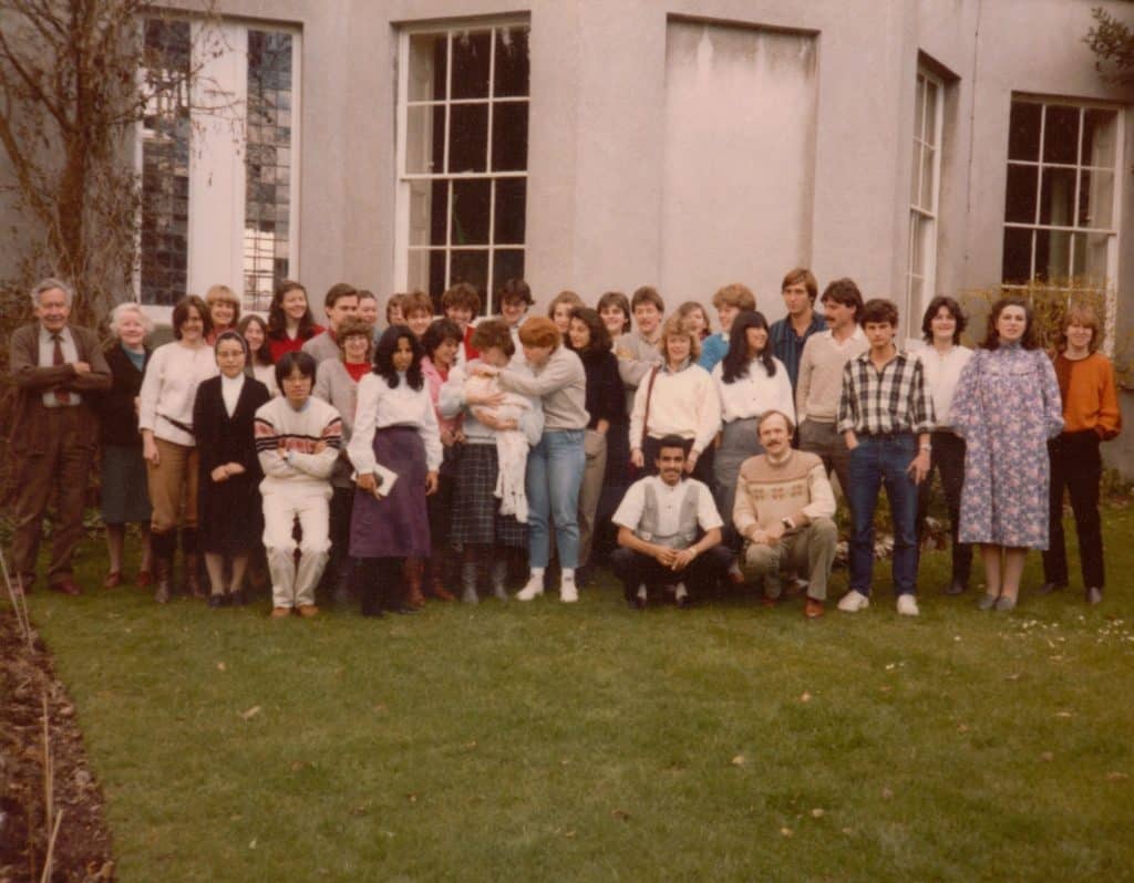 group of international students in the late 70s in front of the Isca School with the Tomlinson Family and baby Sarah