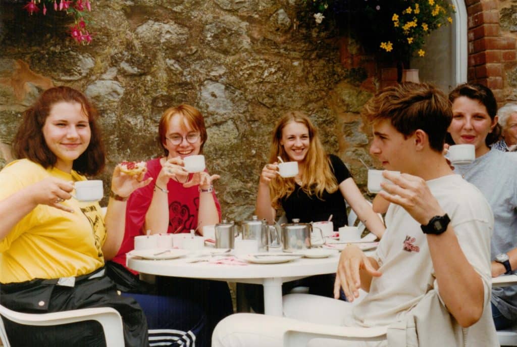a group of international friends enjoying an English Cream tea