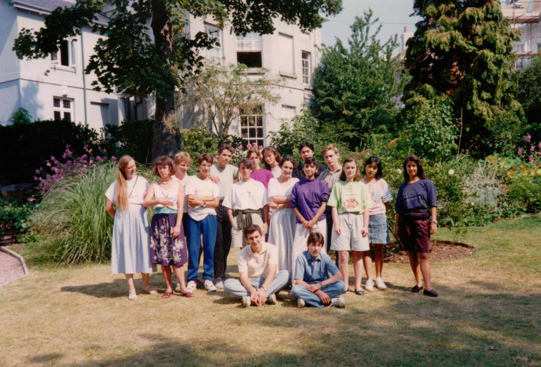 group of international students standing in the front garden with the Isca school of English in the back ground